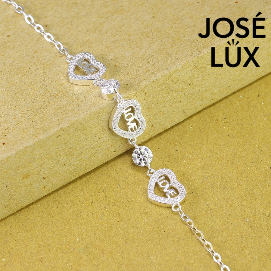 Love script heart station moissanite bracelet in sterling silver showcases three engraved heart charms with brilliant stones totaling 1.02 carats on cable chain.