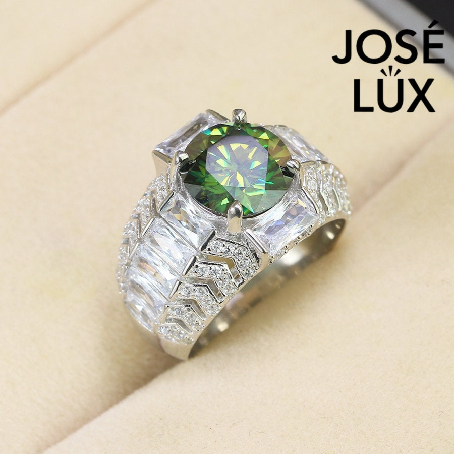 Bold sterling silver men's ring featuring a stunning 4-carat round green moissanite centerpiece surrounded by brilliant baguette-cut accents. Classic design with exceptional sparkle and durability for everyday wear.