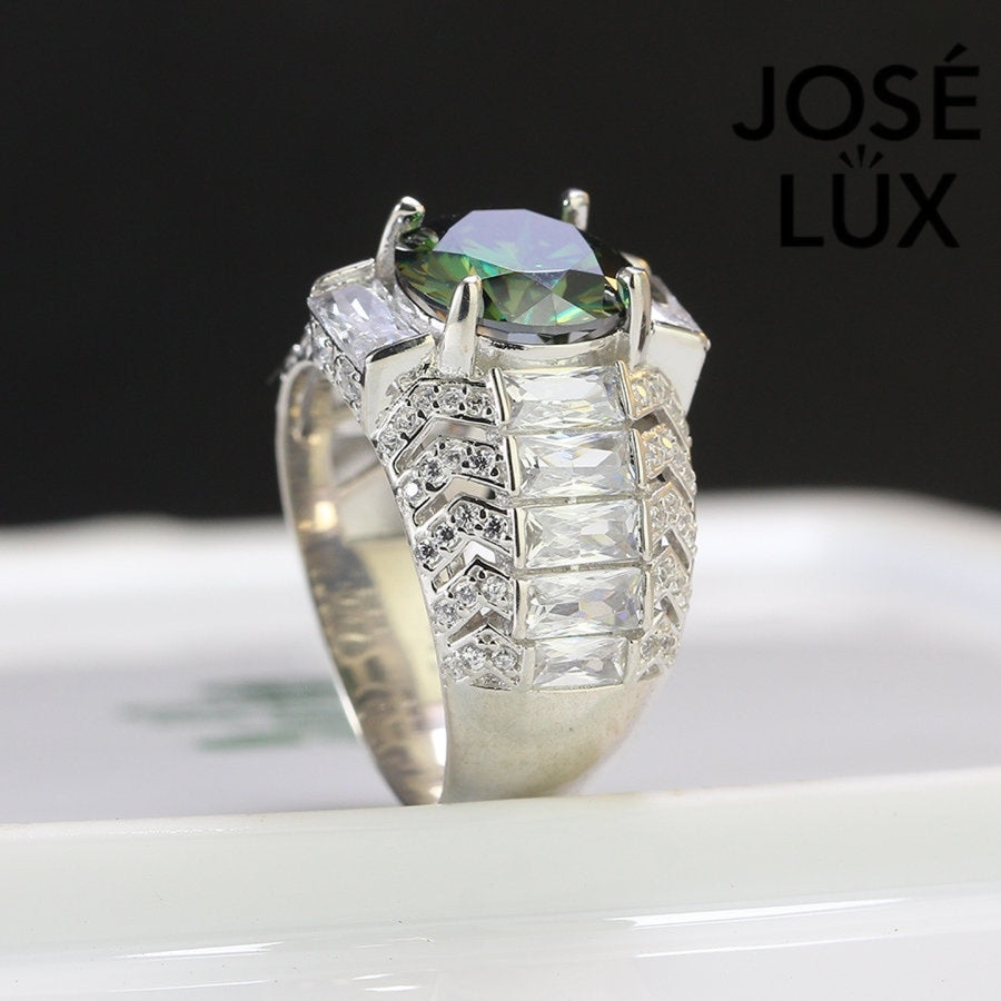 Bold sterling silver men's ring featuring a stunning 4-carat round green moissanite centerpiece surrounded by brilliant baguette-cut accents. Classic design with exceptional sparkle and durability for everyday wear.