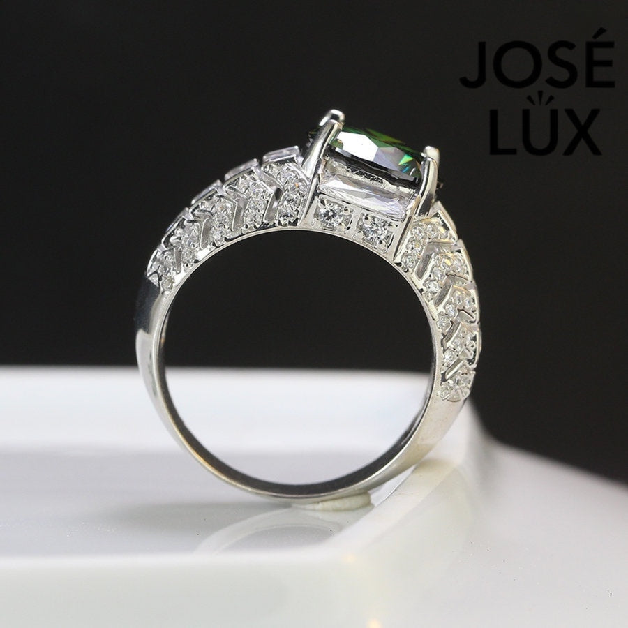 Bold sterling silver men's ring featuring a stunning 4-carat round green moissanite centerpiece surrounded by brilliant baguette-cut accents. Classic design with exceptional sparkle and durability for everyday wear.