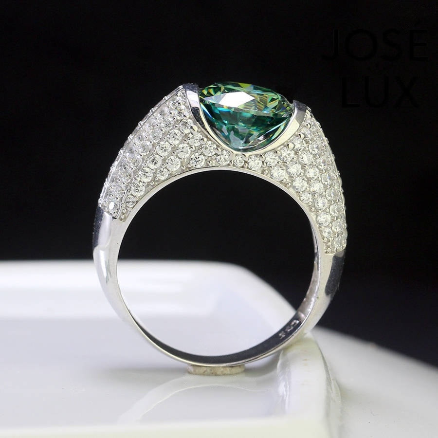 Side view of Men's Sterling Silver Green Moissanite Ring 4CT with Dome Pavé Band displaying the raised green moissanite and intricate pavé band design.