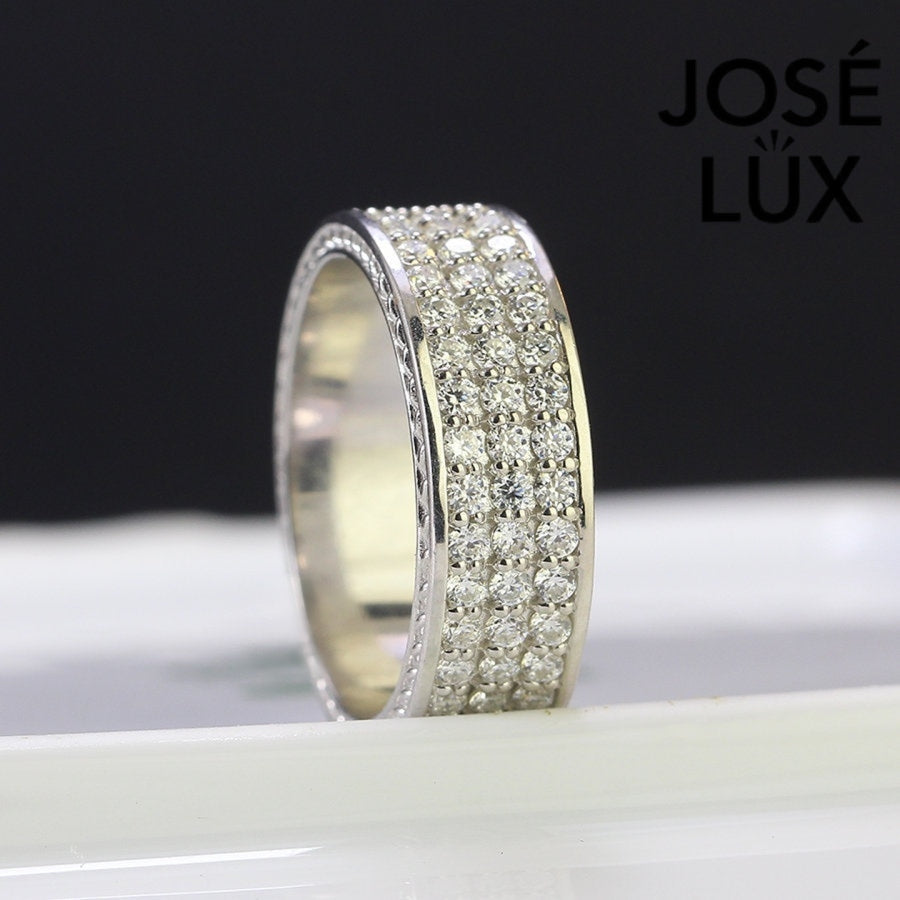 Sterling silver men's band ring features three rows of brilliant-cut moissanite stones in micro-pavé setting. Sleek profile with full coverage delivers continuous sparkle and comfortable fit for daily wear.