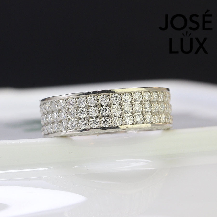 Sterling silver men's band ring features three rows of brilliant-cut moissanite stones in micro-pavé setting. Sleek profile with full coverage delivers continuous sparkle and comfortable fit for daily wear.