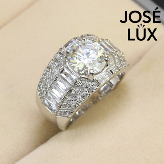 Men's Sterling Silver Moissanite Ring 3CT with Chevron Baguette Band featuring a brilliant round-cut center stone and pavé accents on a beige background.