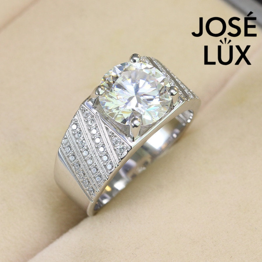 Men's Sterling Silver Moissanite Ring 4CT with Diagonal Pavé Shoulders featuring a brilliant round-cut center stone and pavé accents on a wide band.