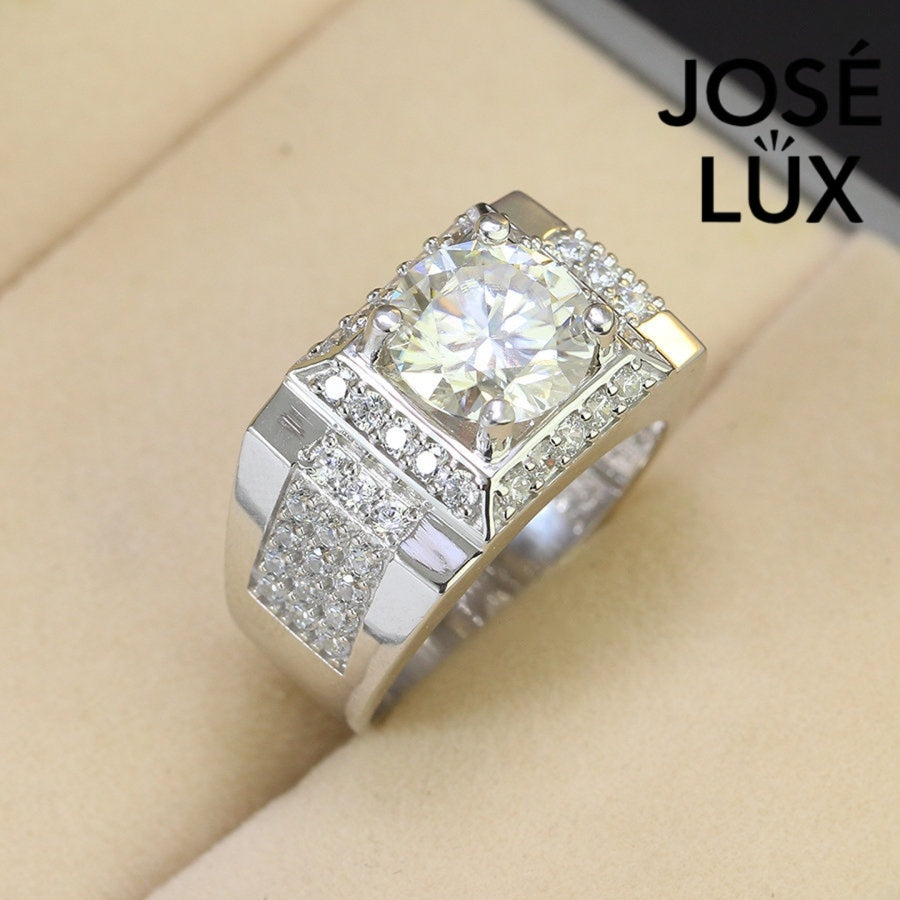 Men's Sterling Silver Moissanite Ring 4CT with Square Halo Platform featuring a large round center stone and pavé side stones on a wide band.