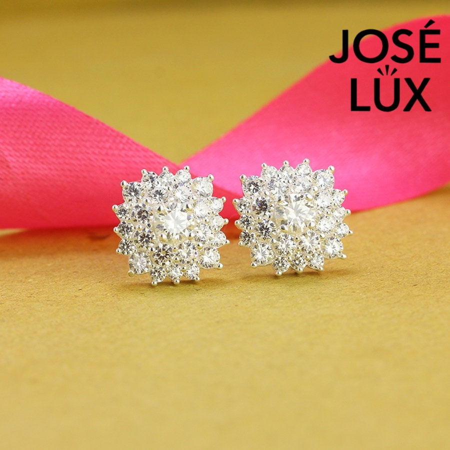 Dazzling bloom-inspired moissanite with sparkling halo setting in sterling silver. Floral design delivers brilliant fire and scintillation for radiant everyday elegance.