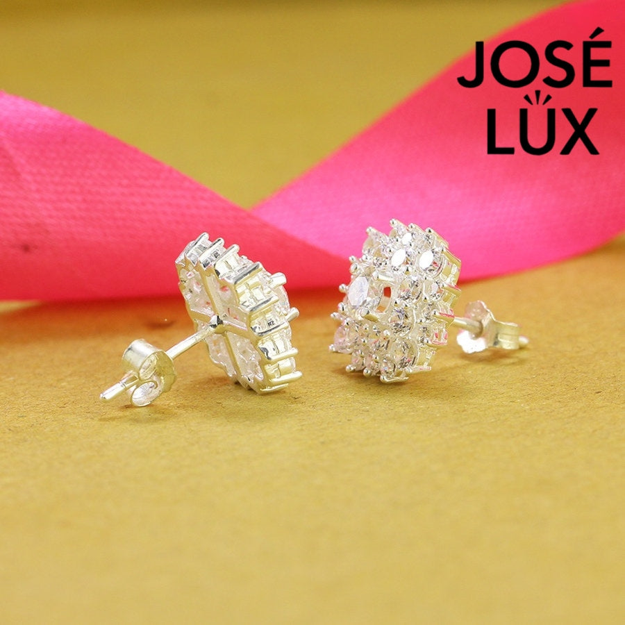 Dazzling bloom-inspired moissanite with sparkling halo setting in sterling silver. Floral design delivers brilliant fire and scintillation for radiant everyday elegance.