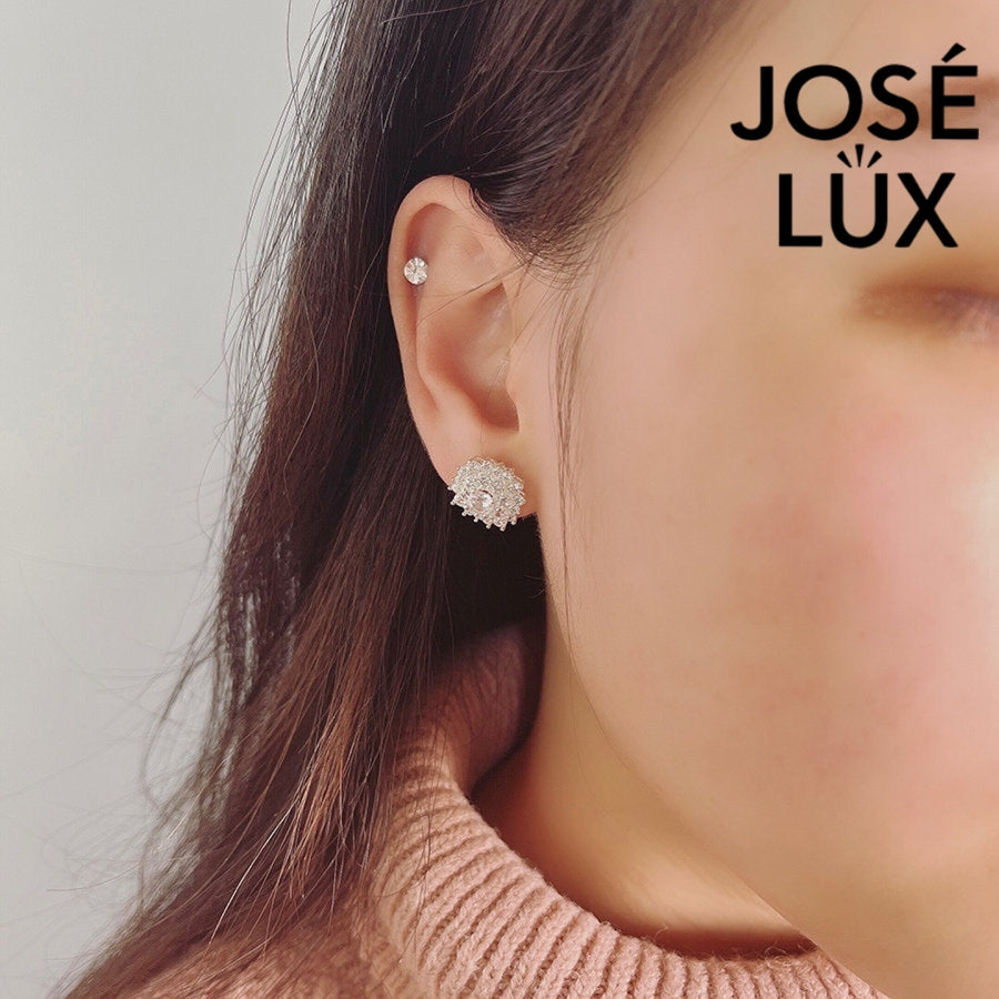 Dazzling bloom-inspired moissanite with sparkling halo setting in sterling silver. Floral design delivers brilliant fire and scintillation for radiant everyday elegance.