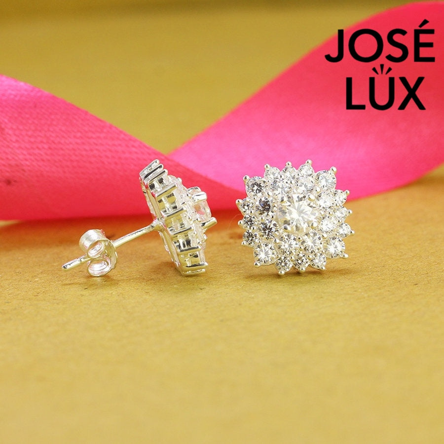 Dazzling bloom-inspired moissanite with sparkling halo setting in sterling silver. Floral design delivers brilliant fire and scintillation for radiant everyday elegance.