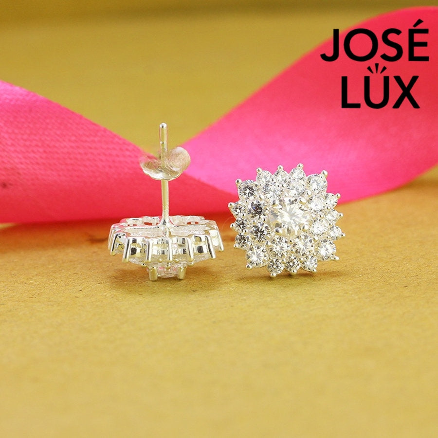 Dazzling bloom-inspired moissanite with sparkling halo setting in sterling silver. Floral design delivers brilliant fire and scintillation for radiant everyday elegance.