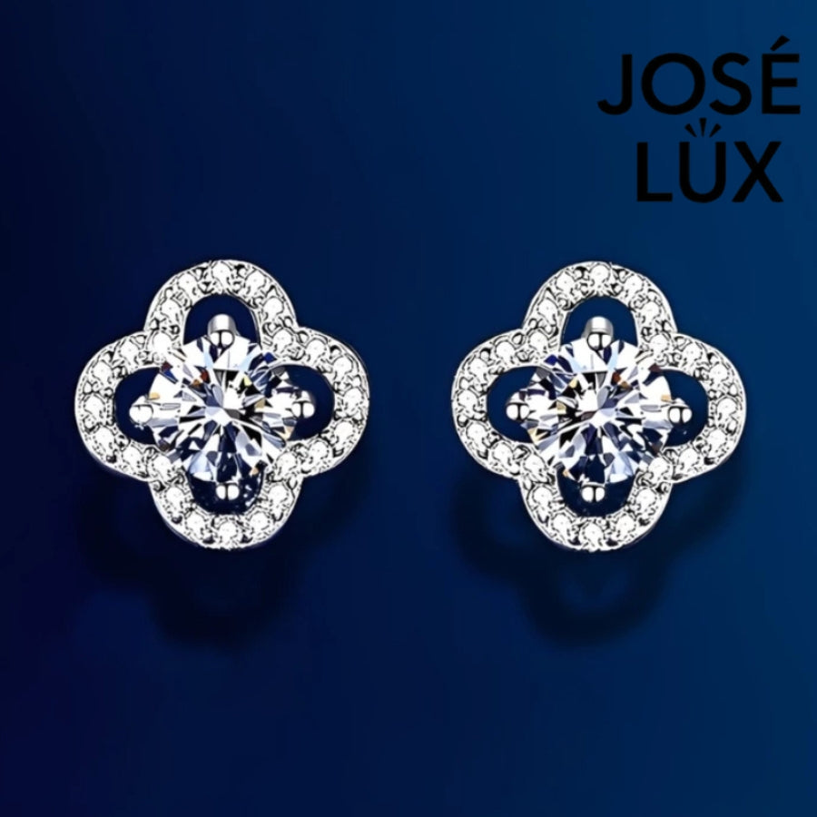 Charming clover-shaped moissanite with sparkling halo setting in sterling silver. Lucky four-leaf design delivers brilliant fire and scintillation for timeless everyday elegance.