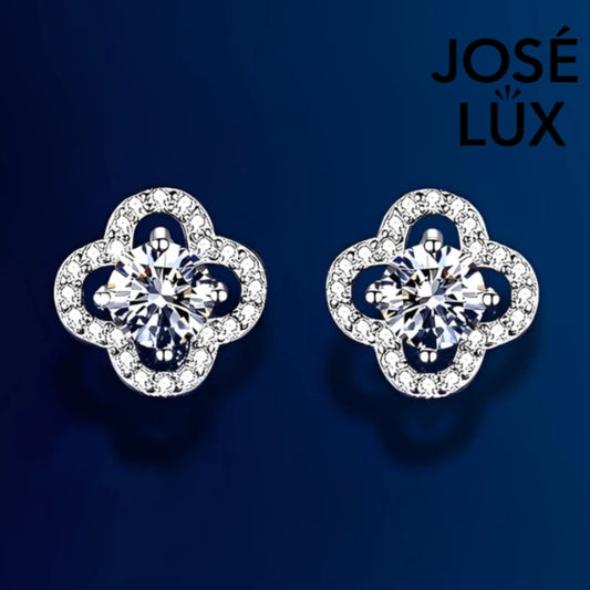 Charming clover-shaped moissanite with sparkling halo setting in sterling silver. Lucky four-leaf design delivers brilliant fire and scintillation for timeless everyday elegance.