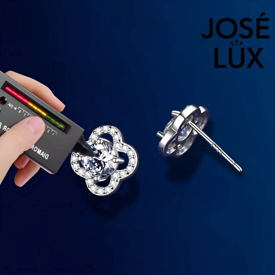 Charming clover-shaped moissanite with sparkling halo setting in sterling silver. Lucky four-leaf design delivers brilliant fire and scintillation for timeless everyday elegance.