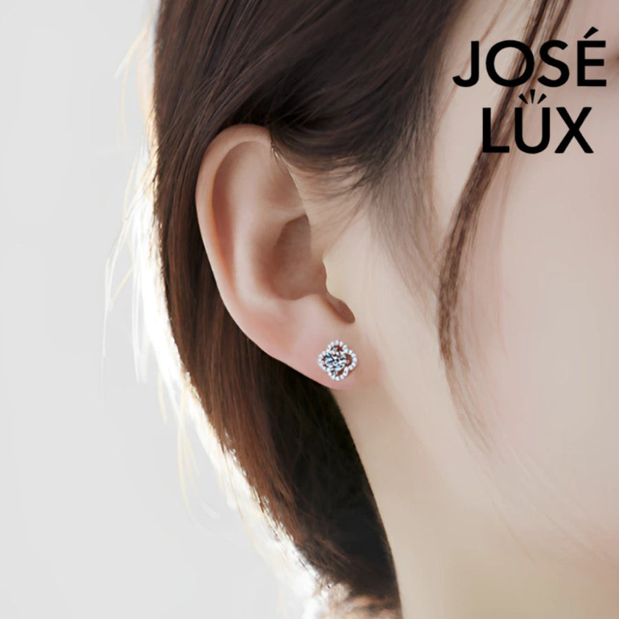 Charming clover-shaped moissanite with sparkling halo setting in sterling silver. Lucky four-leaf design delivers brilliant fire and scintillation for timeless everyday elegance.