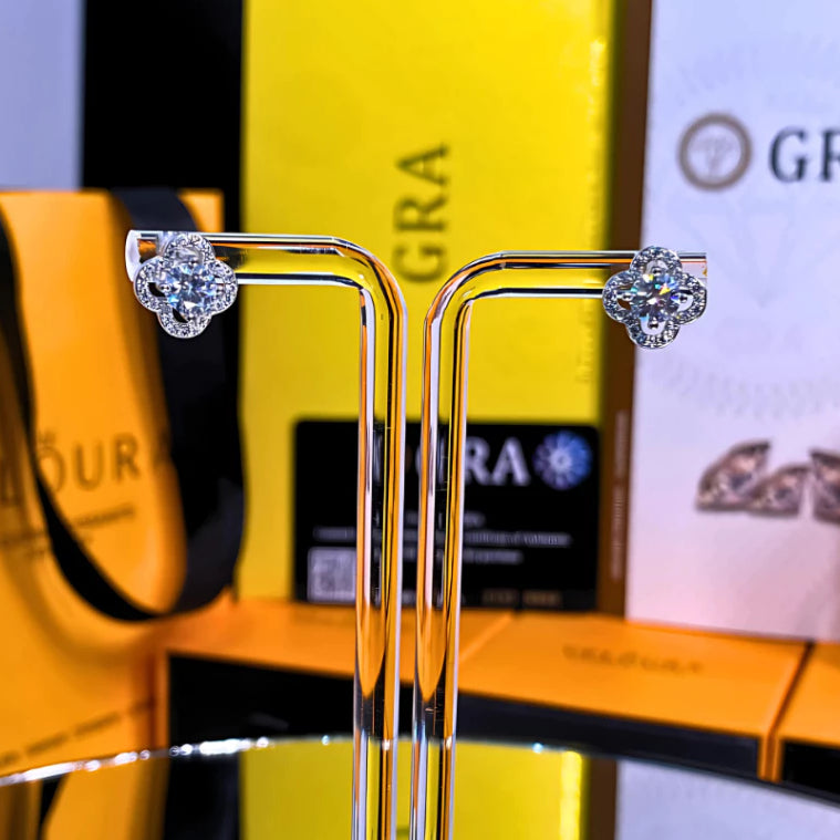 Charming clover-shaped moissanite with sparkling halo setting in sterling silver. Lucky four-leaf design delivers brilliant fire and scintillation for timeless everyday elegance.