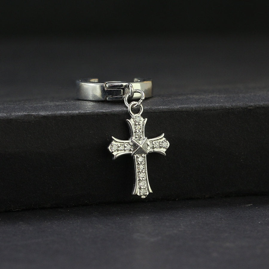 Moissanite Cross Charm Huggie Hoop for Men in sterling silver with pavé stones, displayed on a black surface for a luxury jewelry look.