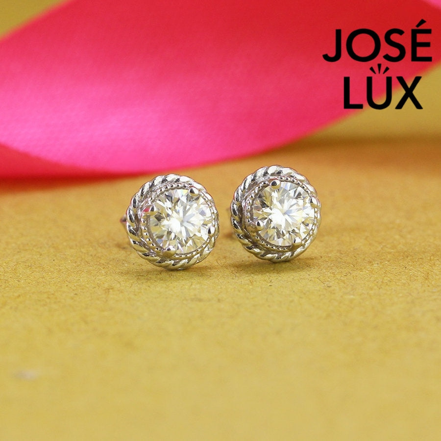 Elegant round moissanite with crown bezel setting in sterling silver. Regal design delivers brilliant fire and exceptional clarity for sophisticated everyday elegance.