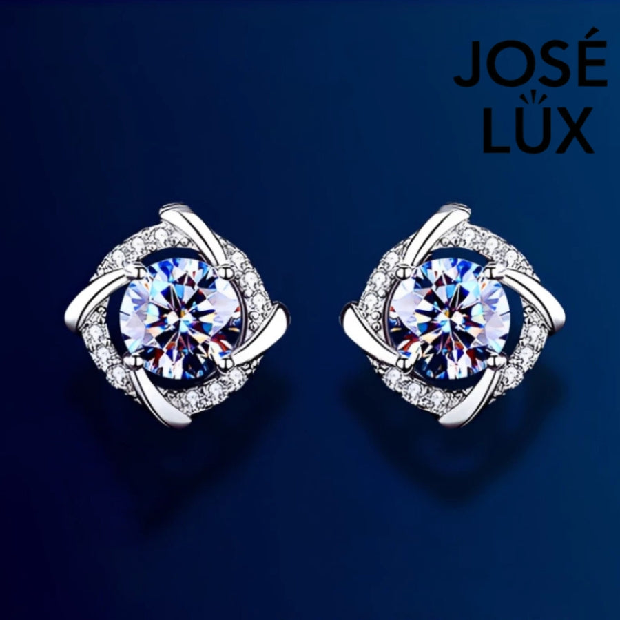 Brilliant cushion-cut moissanite with sparkling halo setting in sterling silver. Timeless elegance and exceptional fire make these studs perfect for everyday sophistication.