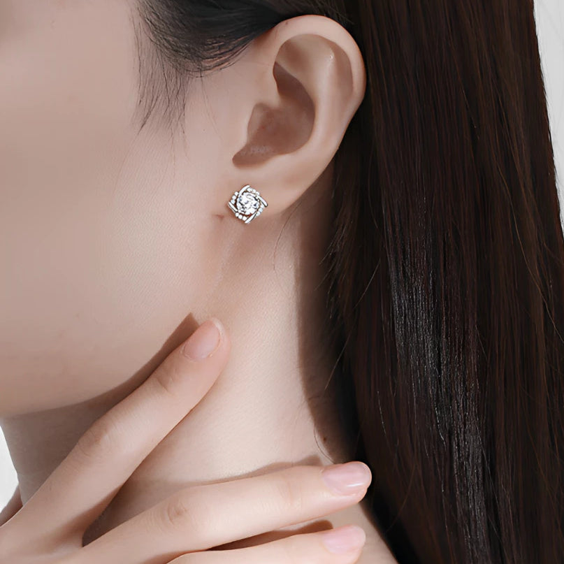 Brilliant cushion-cut moissanite with sparkling halo setting in sterling silver. Timeless elegance and exceptional fire make these studs perfect for everyday sophistication.