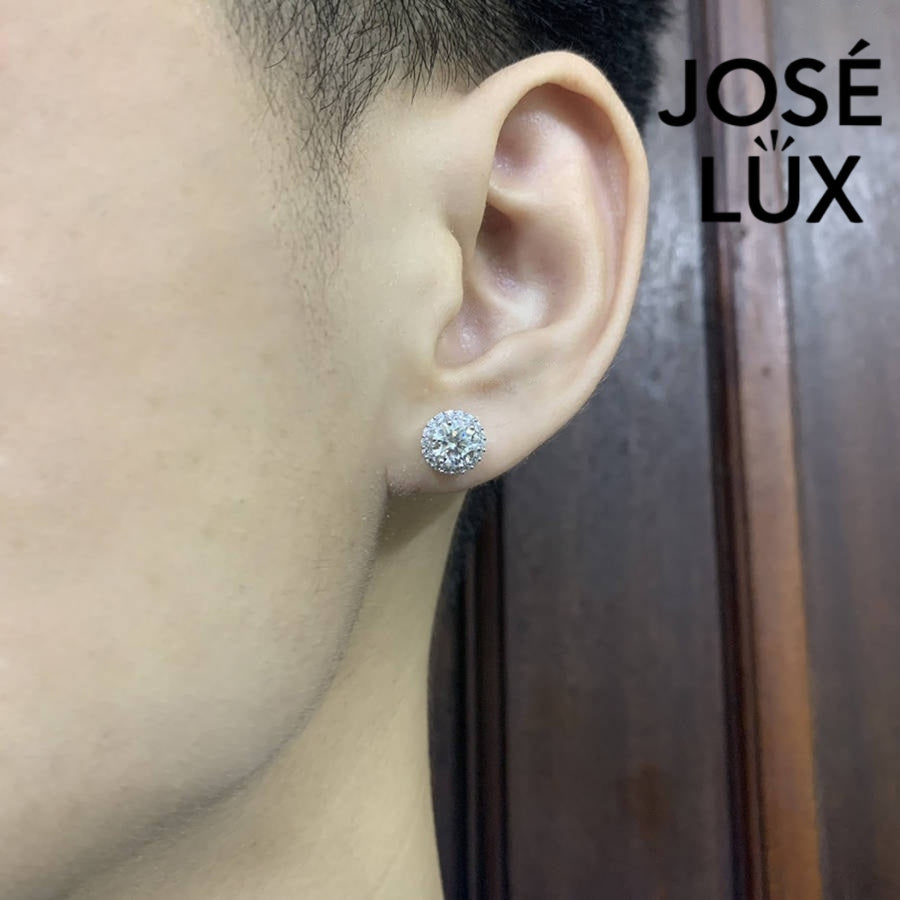 Sterling silver halo studs with 0.8ct round moissanite. Classic design features a brilliant center stone surrounded by smaller accents with secure push-back posts for everyday elegance