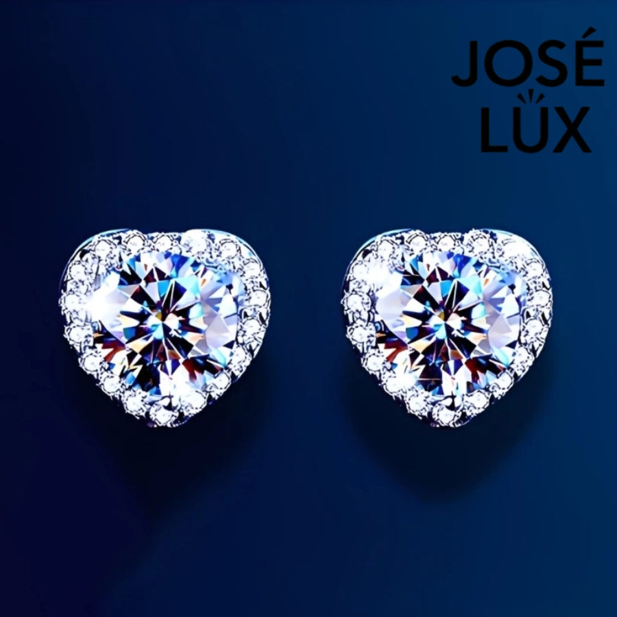 Elegant heart-shaped moissanite earrings with sparkling halo setting in sterling silver. Perfect for daily wear or special occasions with brilliant fire and exceptional clarity.