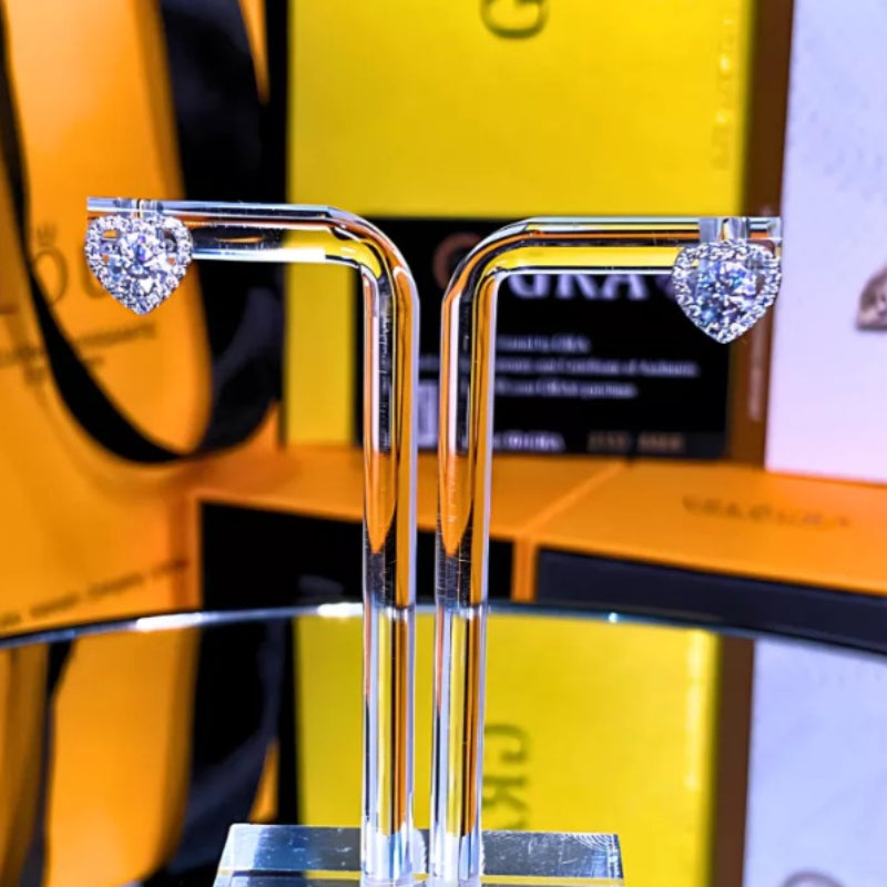 Elegant heart-shaped moissanite earrings with sparkling halo setting in sterling silver. Perfect for daily wear or special occasions with brilliant fire and exceptional clarity.