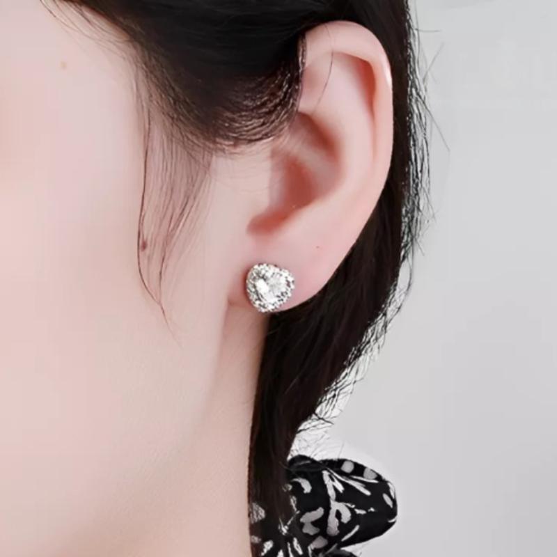 Elegant heart-shaped moissanite earrings with sparkling halo setting in sterling silver. Perfect for daily wear or special occasions with brilliant fire and exceptional clarity.