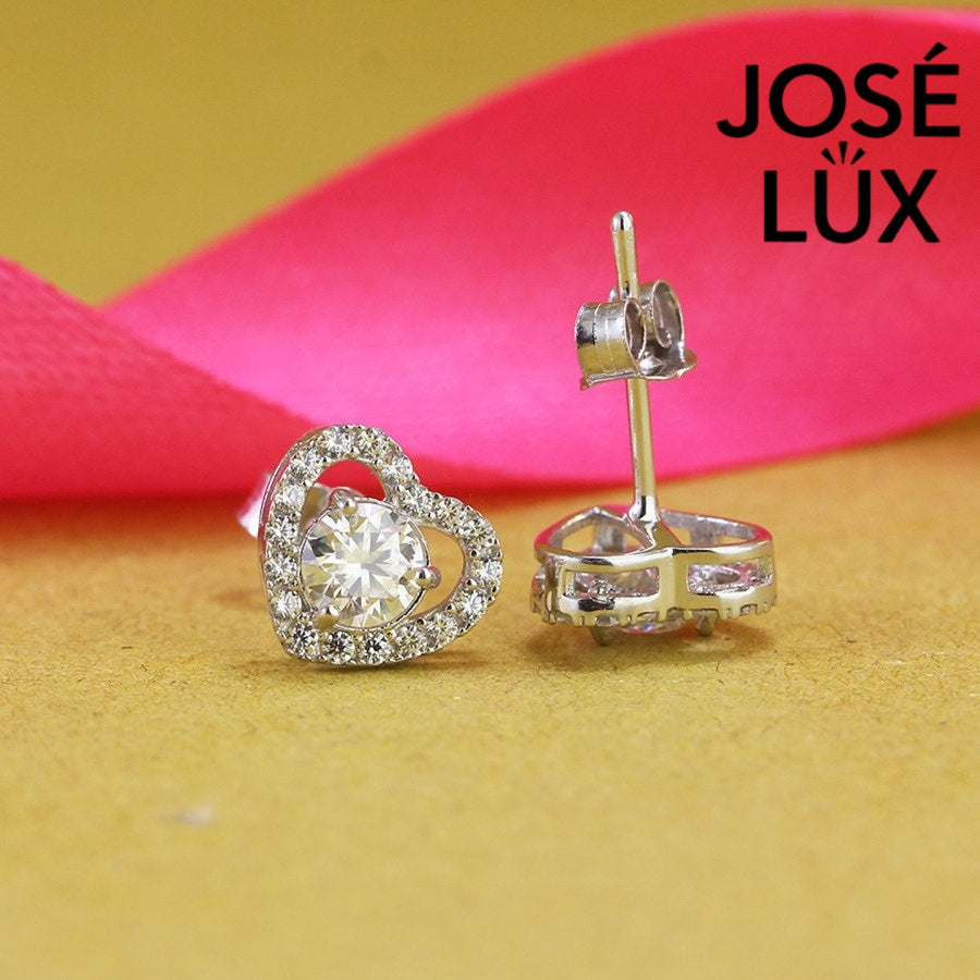 Romantic heart-shaped moissanite with sparkling halo setting in sterling silver. Sweet love-inspired design delivers brilliant fire and scintillation for charming everyday elegance.