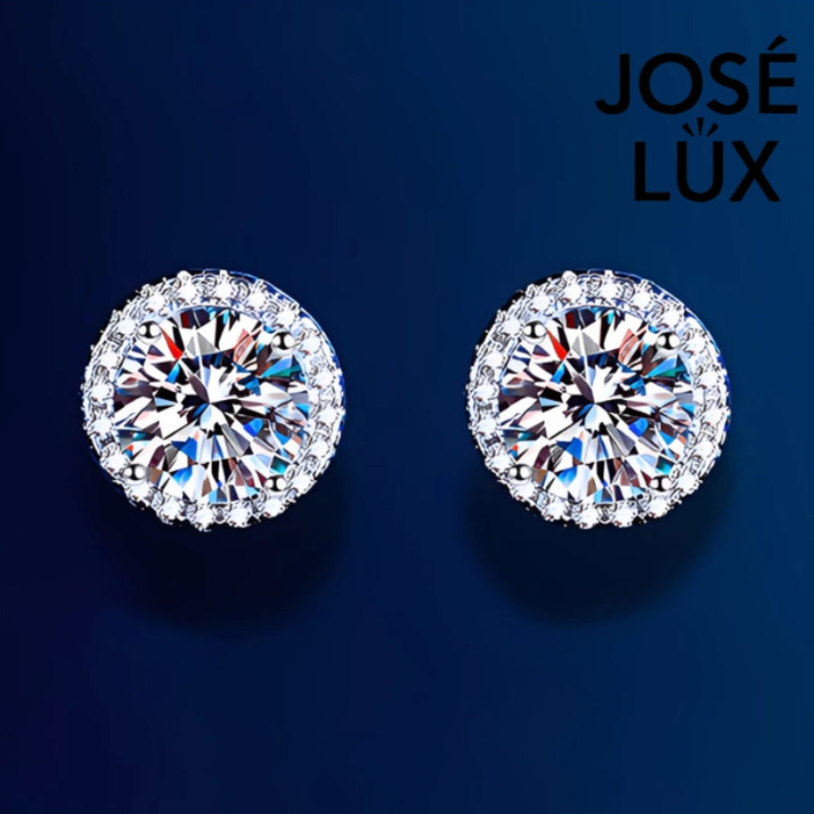 Classic round moissanite with sparkling halo setting in sterling silver. Timeless design offers brilliant fire and exceptional clarity for effortless everyday elegance.