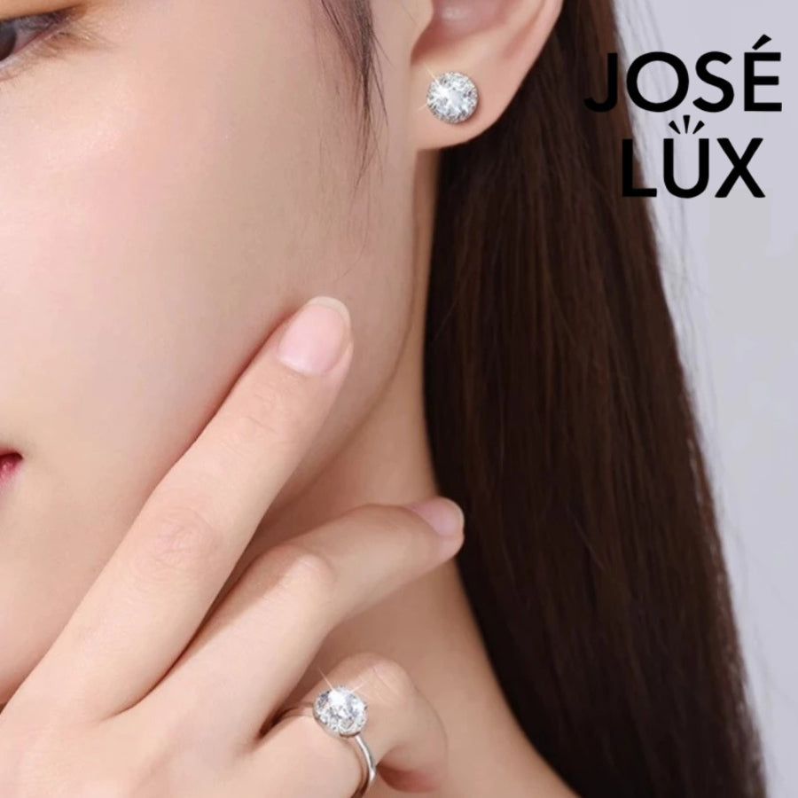 Classic round moissanite with sparkling halo setting in sterling silver. Timeless design offers brilliant fire and exceptional clarity for effortless everyday elegance.