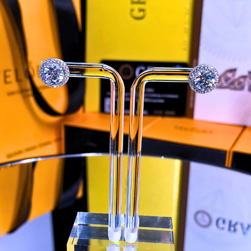 Classic round moissanite with sparkling halo setting in sterling silver. Timeless design offers brilliant fire and exceptional clarity for effortless everyday elegance.