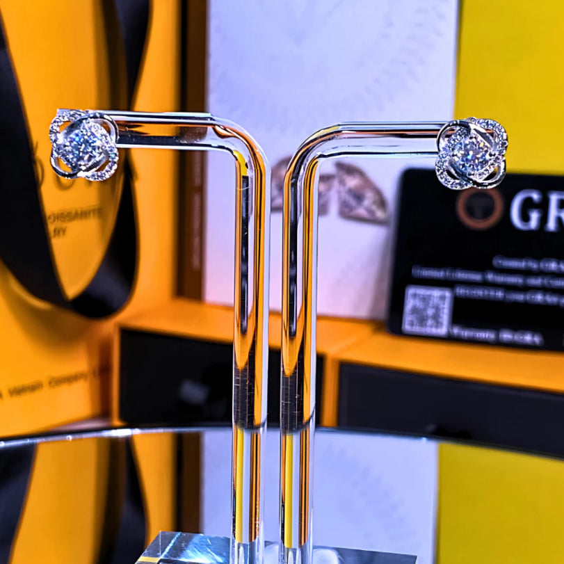 Elegant twisted halo design featuring brilliant moissanite stones in sterling silver. Modern sculptural styling adds sophisticated sparkle to any outfit with exceptional fire.