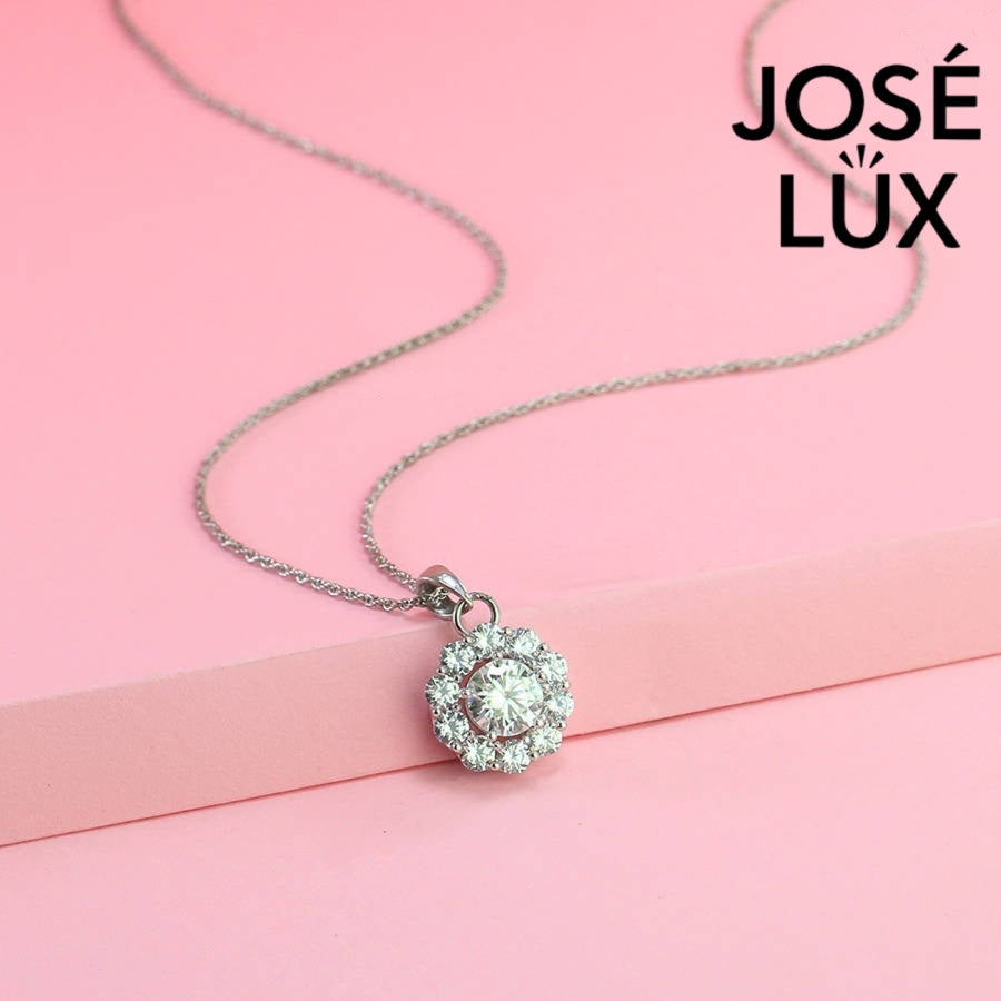 Timeless round moissanite pendant surrounded by scalloped halo design creates vintage-inspired elegance, expertly handcrafted in lustrous sterling silver for lasting beauty.