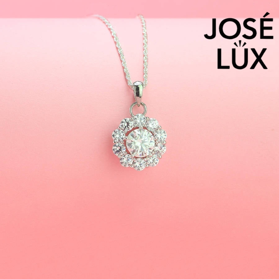 Timeless round moissanite pendant surrounded by scalloped halo design creates vintage-inspired elegance, expertly handcrafted in lustrous sterling silver for lasting beauty.