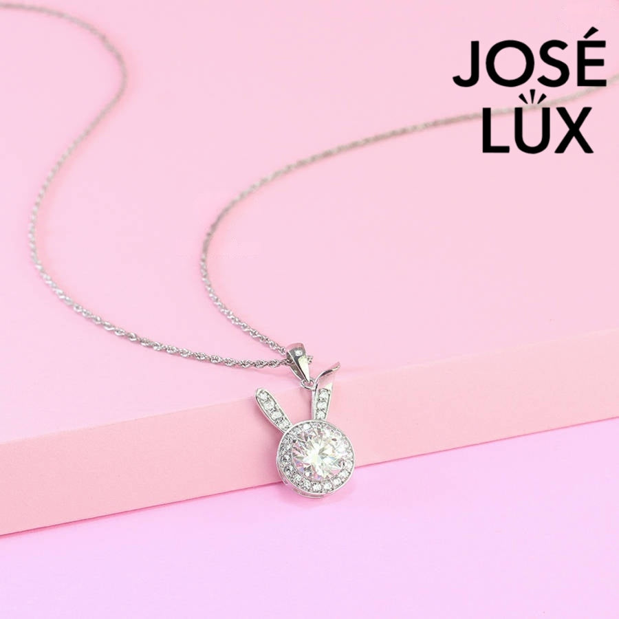 Charming round moissanite halo pendant features playful bunny ear accents with pavé stones, creating a whimsical statement piece in sterling silver.