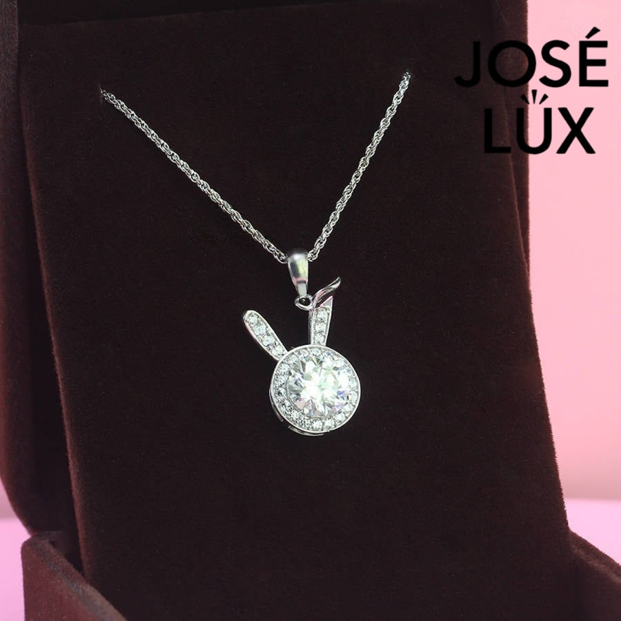 Charming round moissanite halo pendant features playful bunny ear accents with pavé stones, creating a whimsical statement piece in sterling silver.