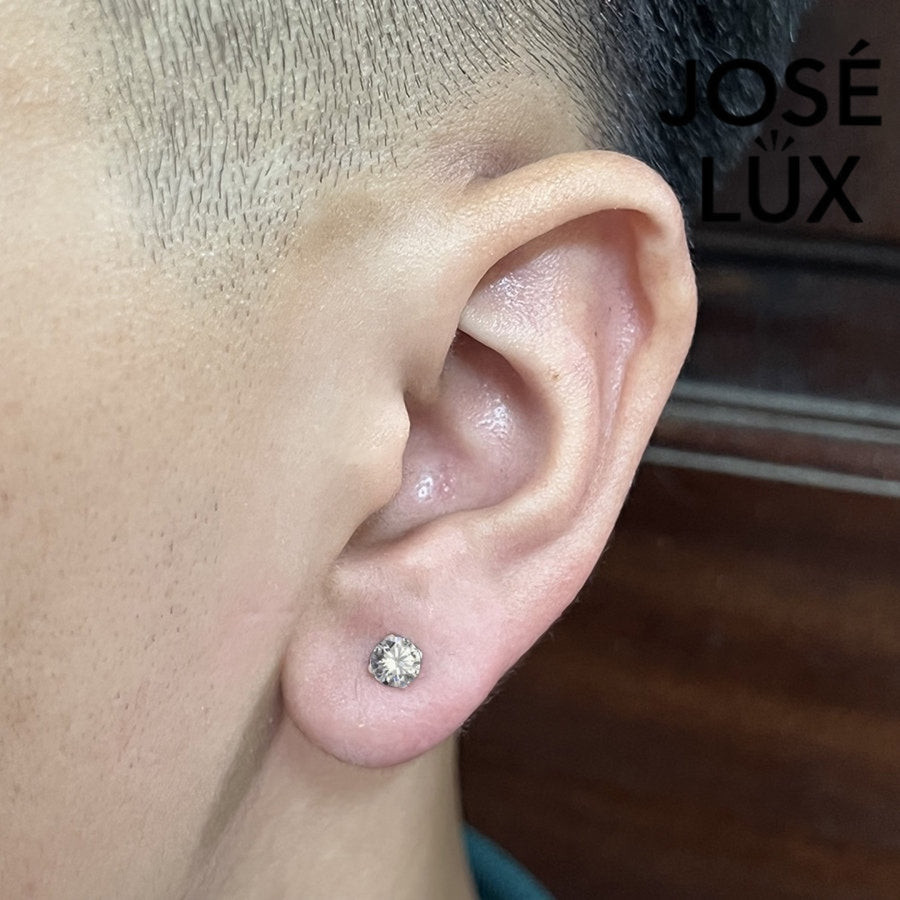 Men's 0.5ct Round Moissanite Stud Earring worn on ear, showcasing sterling silver 4-prong setting and secure fit.