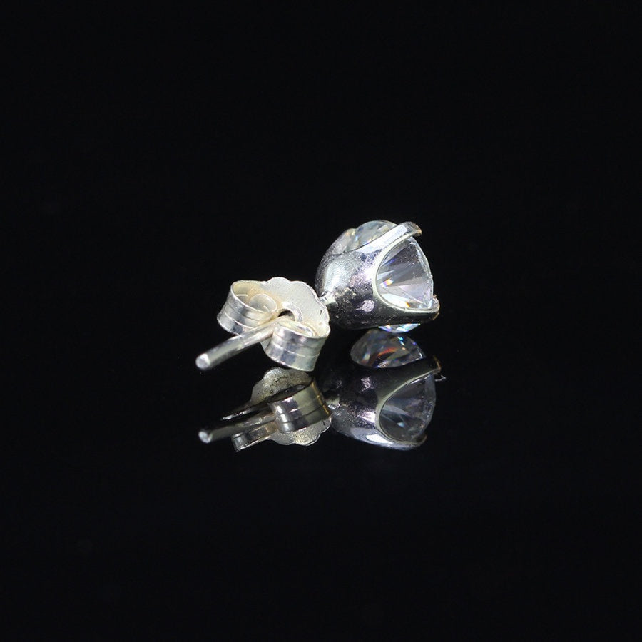 Angled close-up of 0.8ct moissanite stud earring in sterling silver, showing brilliance and 4-prong craftsmanship.