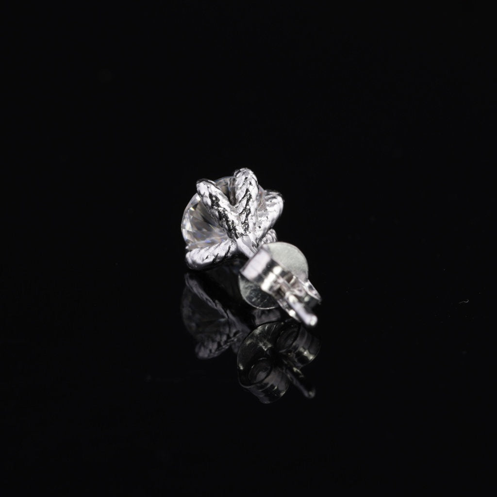 Angled view of 0.8ct Moissanite stud earring for men in sterling silver with intricate 8-prong design and secure post.