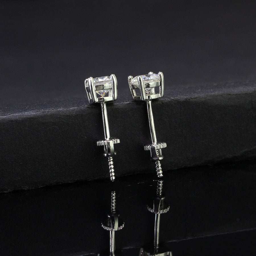 Sterling silver studs featuring 0.5ct round moissanite in classic prong setting. Brilliant-cut stones offer exceptional fire and sparkle with secure screw-back posts for everyday comfort and protection.