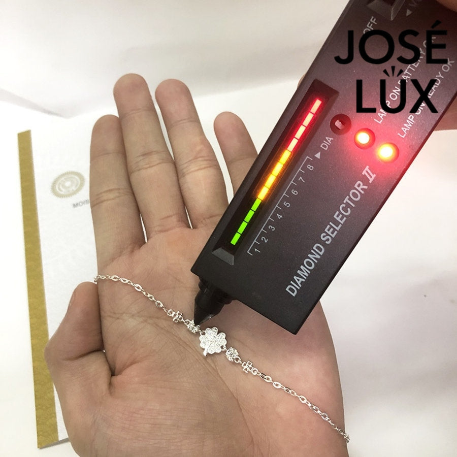 Star clover station moissanite bracelet in sterling silver showcases pave-set four-leaf clover centerpiece with brilliant stones totaling 0.6 carats on cable chain.