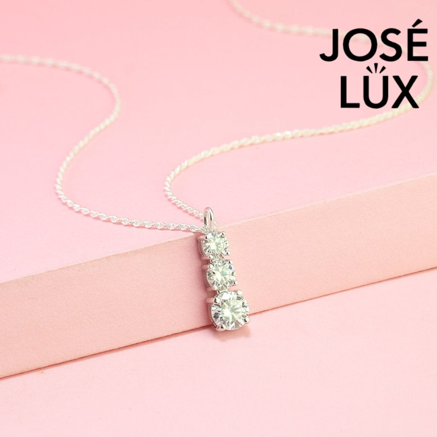 Elegant three-stone graduated moissanite pendant features brilliant round stones in classic drop design, crafted in durable sterling silver for everyday elegance.