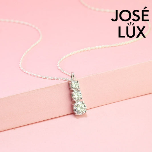 Elegant three-stone graduated moissanite pendant features brilliant round stones in classic drop design, crafted in durable sterling silver for everyday elegance.