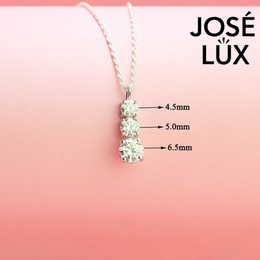 Elegant three-stone graduated moissanite pendant features brilliant round stones in classic drop design, crafted in durable sterling silver for everyday elegance.