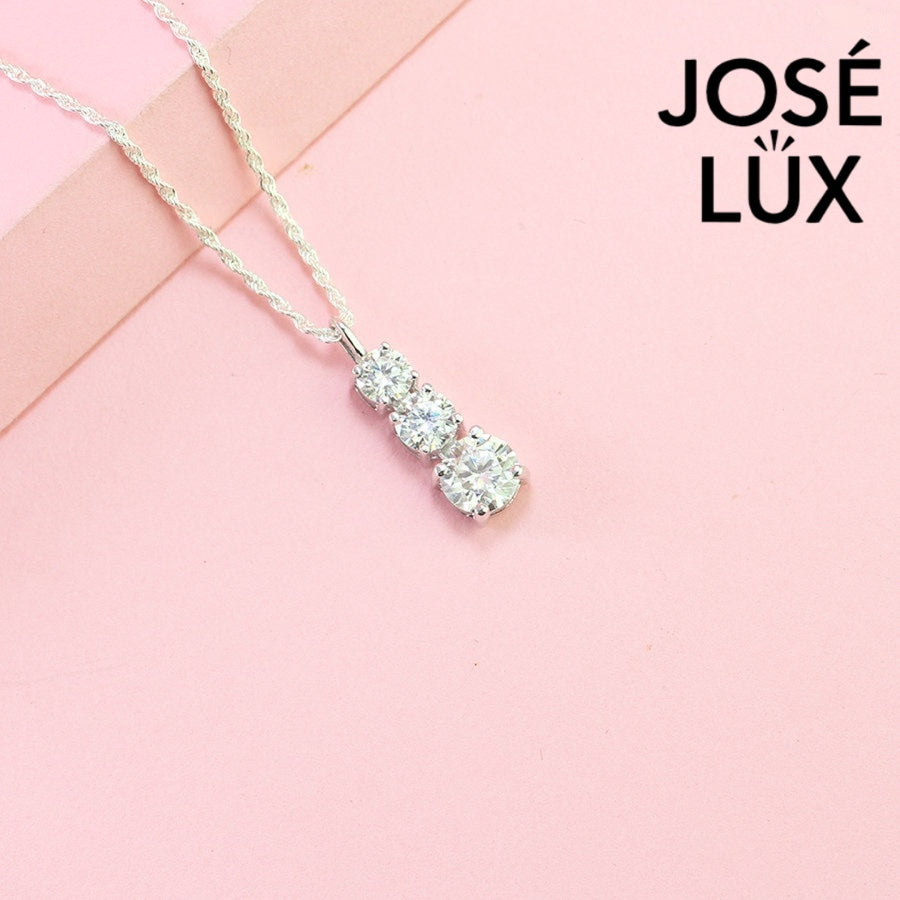 Elegant three-stone graduated moissanite pendant features brilliant round stones in classic drop design, crafted in durable sterling silver for everyday elegance.