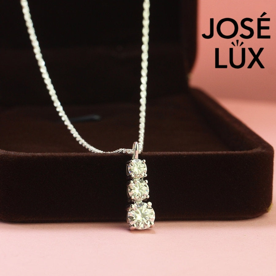 Elegant three-stone graduated moissanite pendant features brilliant round stones in classic drop design, crafted in durable sterling silver for everyday elegance.