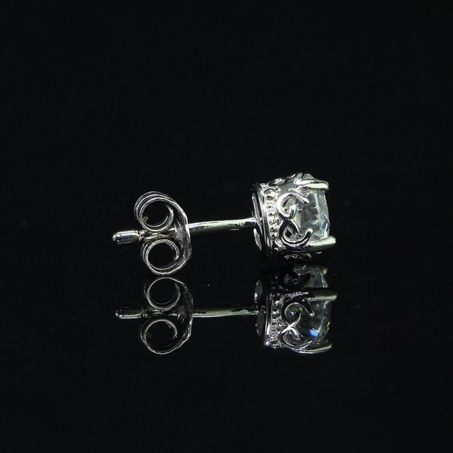 Side view of vintage crown moissanite stud earring for men, featuring ornate sterling silver setting and push-back closure.